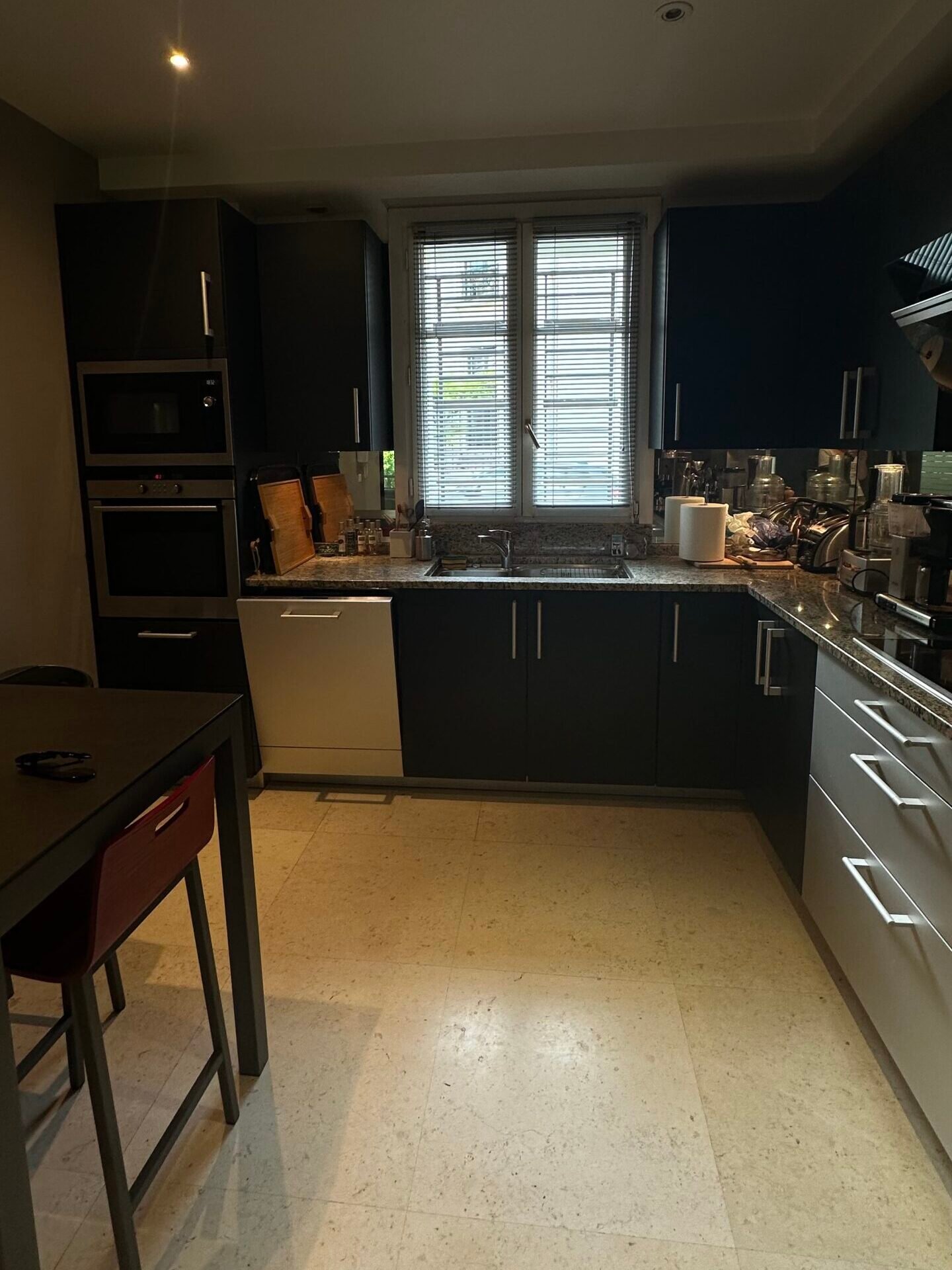 Cuisine sombre aux façades noires et plan en granit avant rénovation – maison Charenton-le-Pont